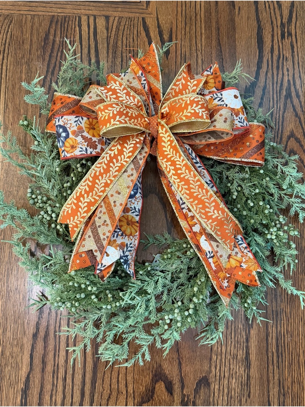 Autumn Orange Ribbon Holiday Wreath with Green Foliage